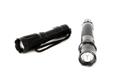 Small black flashlight on a white background. Lantern Stock Photos