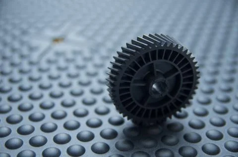 Small black plastic mechanical wheel used during print screen process, lying on 스톡 사진