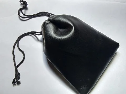 Small black pouch, on white background. Фото