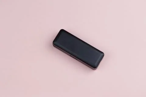 Small black rectangular plastic container on a pink background 스톡 사진