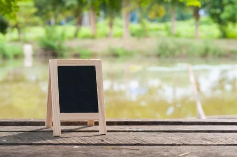 Small blackboard on rustic wood table Stock Photos