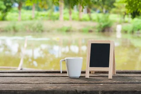 Small blackboard on rustic wood table Stock Photos