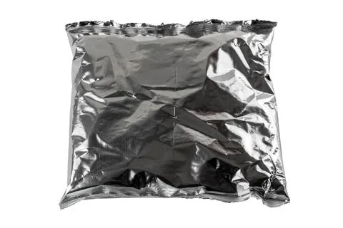 Small blank single-use crumpled aluminum foiled plastic bag isolated on white Stock Photos