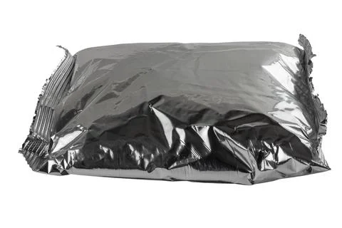 Small blank single-use crumpled aluminum foiled plastic bag isolated on white Stock Photos