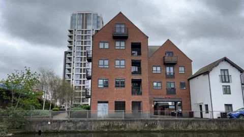 Small block of modern flat by the river in the UK Stock Footage 332117787