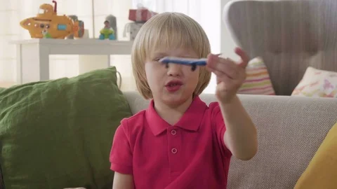 Small blonde boy kid play miniature airplane dreaming to be pilot as future Stock Footage 78295028