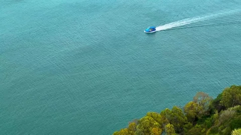 Small Blue Boat Sailing on Tagus Sea Stock-Footage 258774416