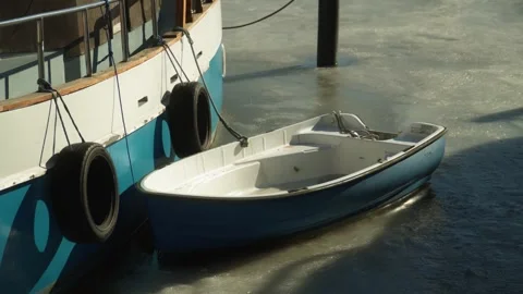 A small blue boat stuck in the frozen sea Stock Footage 314736587