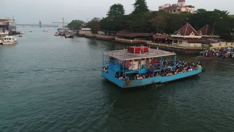 A small blue ferry approaches the shore. Drone view. Video stock 85556552