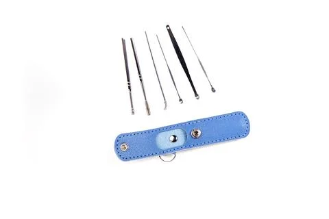 Small blue leather keychain kit with ear wax tools isolated over white Stock Photos