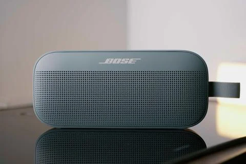 A small bluetooth speaker bose soundlink flex in low light Stock Photos