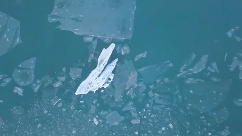 A small boat among icebergs in Disko Bay glacier during midnight sun Ilulissat. Stock Footage 128794499