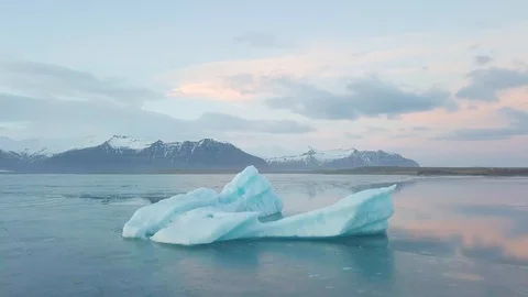A small boat among icebergs in Disko Bay glacier during midnight sun Ilulissat. Stock Footage 128795657