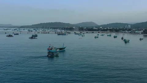 Small boat and big ship together in the harbour early in the morning in the dusk Stock Footage 124107060