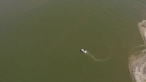 Small boat off of beach shore Stock Footage 76378702