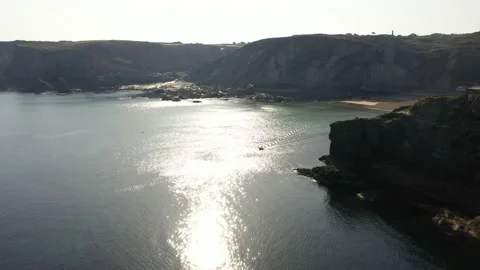 Small boat, big cliffs and sea 動画素材 168420369