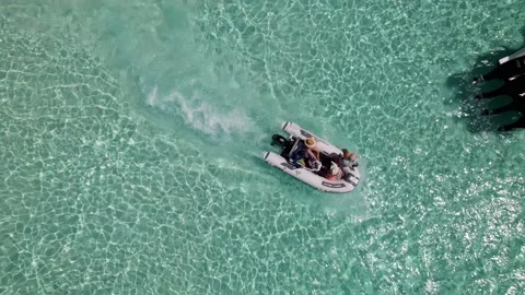 Small boat at Bimini beach going through other boats Stock Footage 232437473