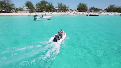 Small boat at Bimini beach going arround Stock Footage 232437489