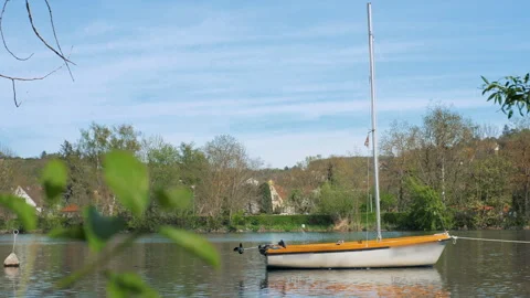 A small boat is on a calm river. During sunset Stock Footage 272619947