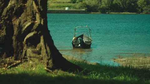 Small boat cruising on calm river with reflections Stock Footage 317007003