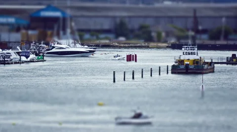 Small boat cruses down the channel Tilt Shift HD Stock Footage 6530906