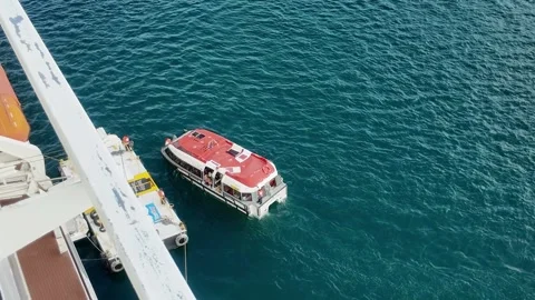Small Boat Docking with Cruise Ship to Embark Passengers Stock Footage 297213516