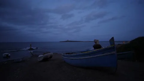 Small boat at dusk in small sicilin village Stock Footage 220064091