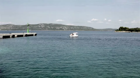 Small boat entering a harbor Stock Footage 41471553