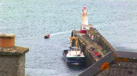 Small boat entering harbor Stock Footage 62469145