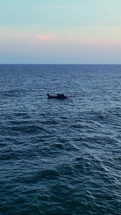 Small boat floating on calm blue ocean Stock Footage 335432899