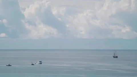 Small boat floating on a calm ocean with a clear sky in 4k Stock Footage 279944160