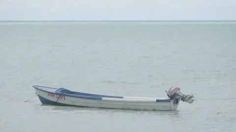 Small boat floating on the calm sea Stock Footage 340820582