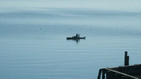Small Boat Floating on Large Body of Water Stock Footage 262218038