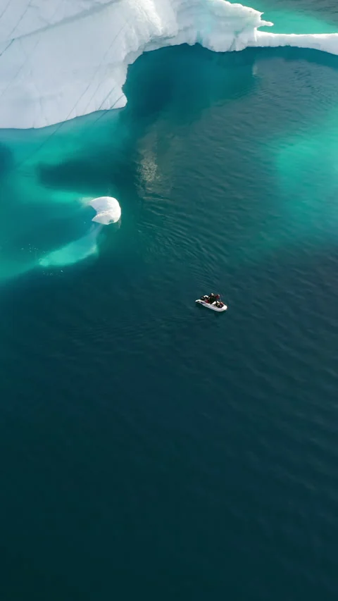Small Boat Floating Near Iceberg Submerged Shelf - Greenland Stock Footage 346335565