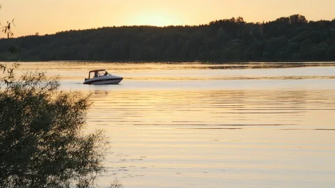 Small Boat Floats on the River at Sunset Stock Footage 89417540