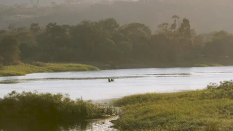 Small boat going down river in Zambia Stock Footage 335029264