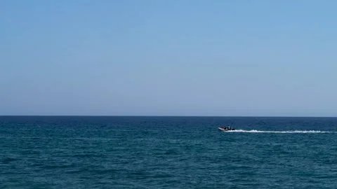 Small boat going at high speed on the sea during a sunny day Stock Footage 152552707