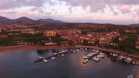 Small Boat Harbor With Mountains behind and Pink Sky  Stock Footage 82401201