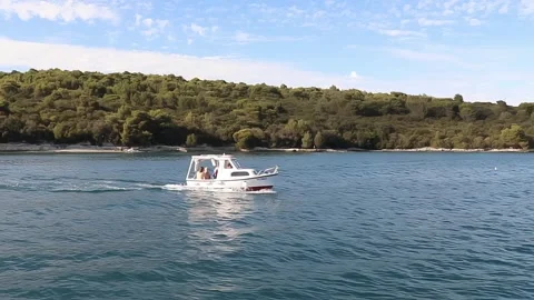 Small Boat Jumps On Waves. Coastline With Forest. Shooting From Nearby Boat. Stock Footage 242589832