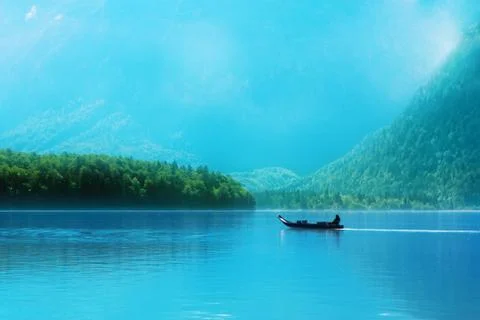 Small boat on a lake in the Alps Stock Photos
