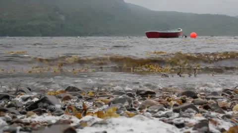 Small boat on loch Stock Footage 25849185