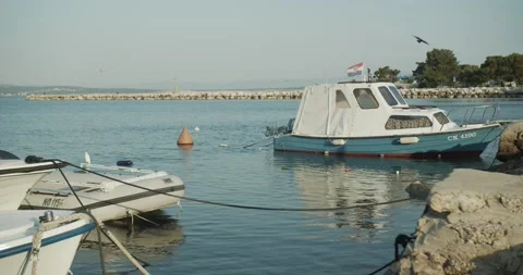 Small boat in midday floating anchor 動画素材 141742220