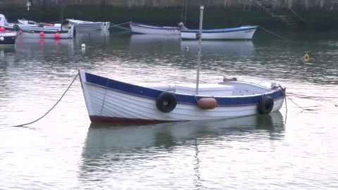 Small boat moored in harbour Stock Footage 277529411