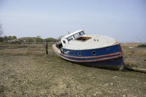Small boat in the mud Stock Photos