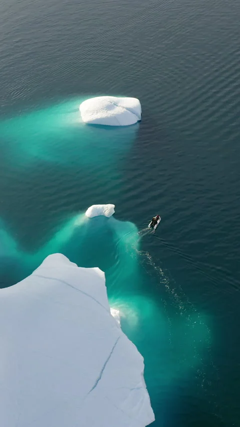 Small Boat Navigating Near Submerged Iceberg Shelf - Greenland Stock Footage 346335833