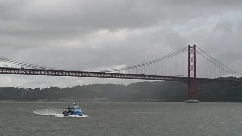 Small boat navigating Tagus River Video stock 328069284