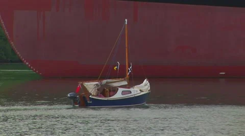 Small boat next to container ship Stock Footage 61575704