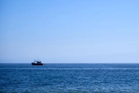 Small boat in the ocean Stock Photos