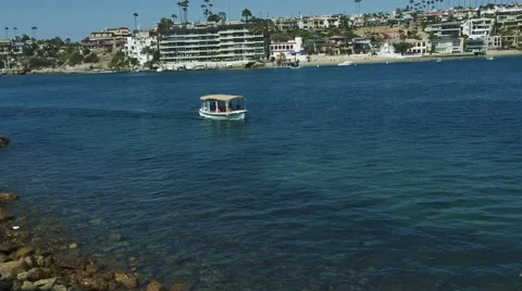 Small boat passing by on the ocean with beautiful scenery in back. Stock Footage 65317456