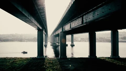 Small Boat passing under a Huge Concrete Car Bridge, Golden Horn, Istanbul Stock Footage 72623768